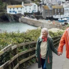 Senior-couple-walking-in-a-village-in-Cornwall-e1654766446581.jpg