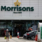 FILE PHOTO: A customer carries a shopping bag outside a Morrisons supermarket in New Brighton, Britain, July 5, 2021. REUTERS/Phil Noble/File Photo
